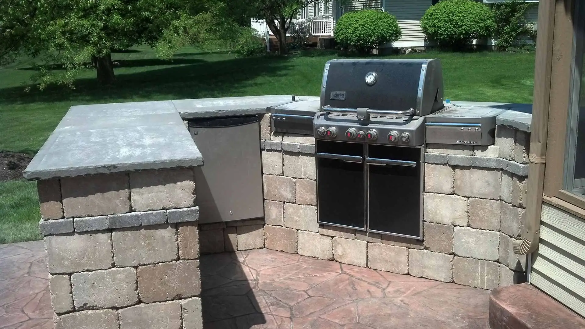 Custom outdoor kitchen installation with a grill in Wyoming, MI.