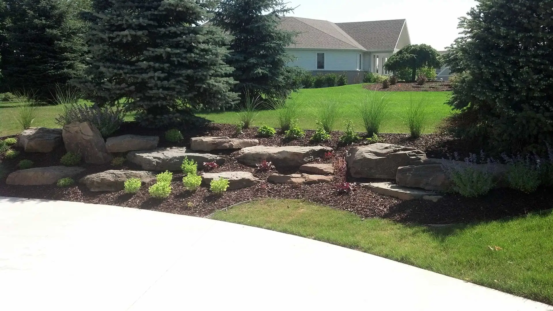 Custom landscaping plant bed at residential property in Grand Rapids, MI.