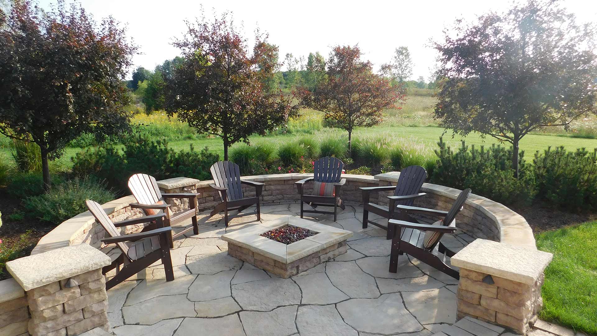 Custom fire pit installed in paved patio in Muskegon, MI.