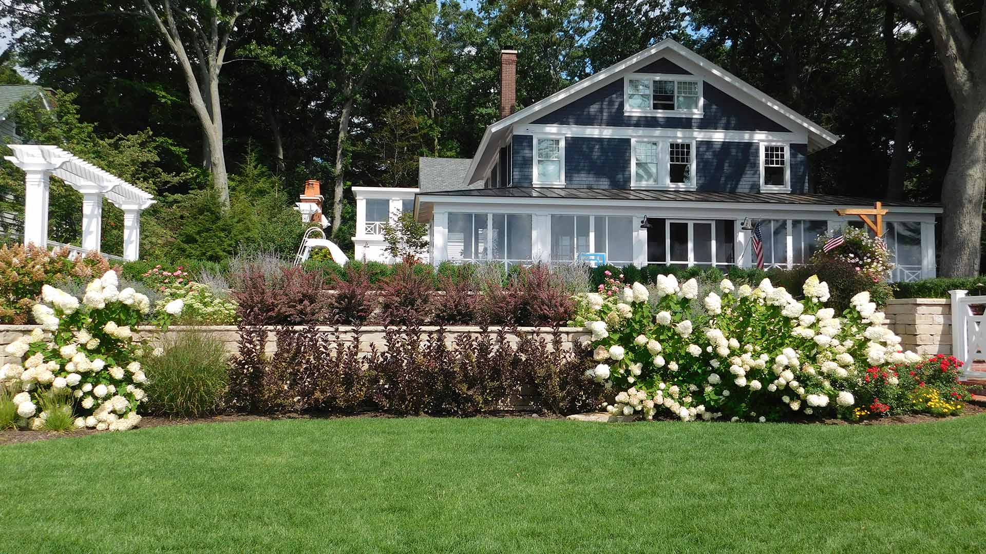 A home with a beautiful landscape and healthy lawn in West Olive, MI.