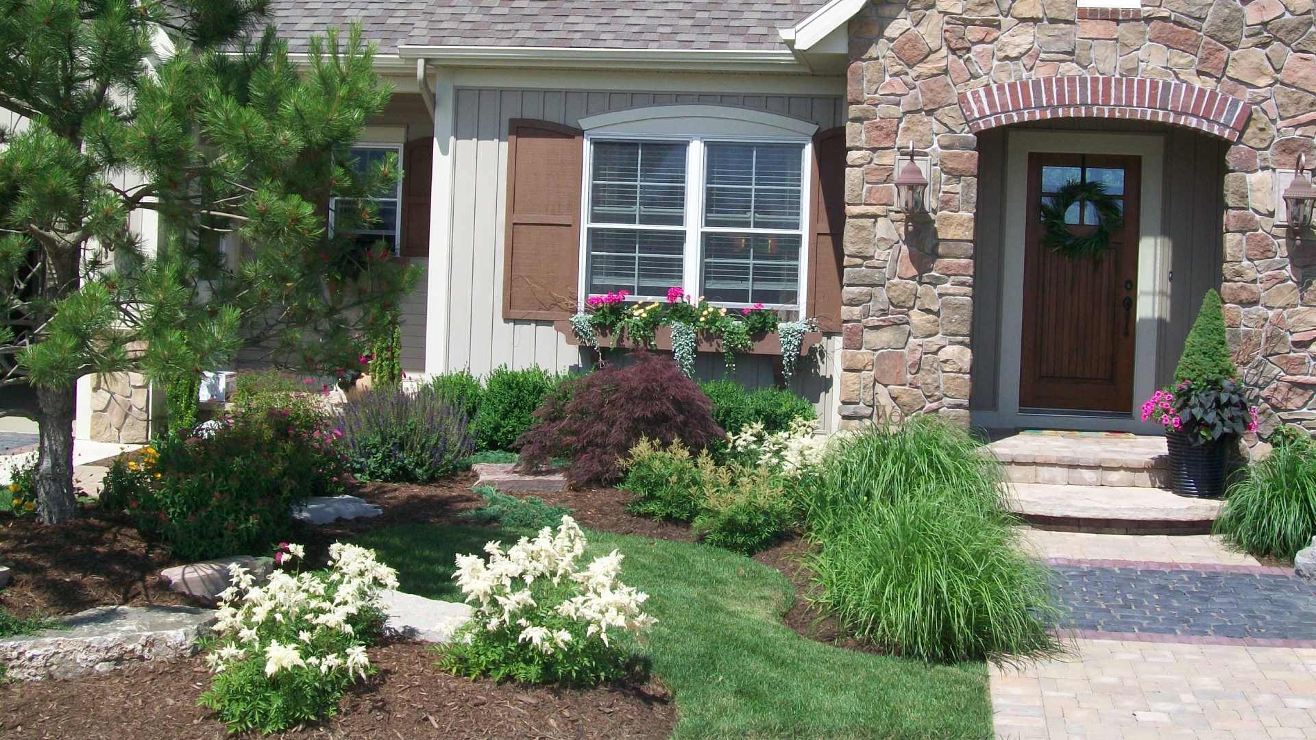 Landscape bed that is well maintained by Rose Landscaping professionals in Marne, MI.