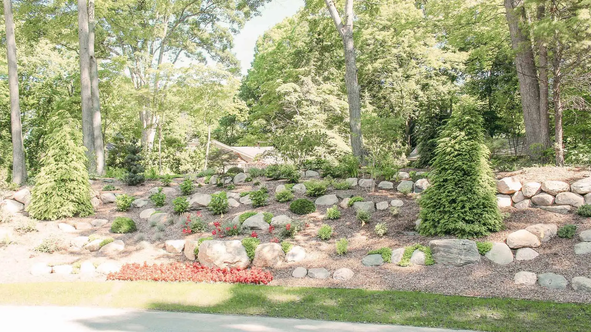 Property with retained walls holding landscape beds in East Grand Rapids, MI.