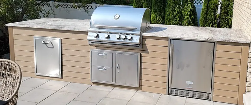 A newly built outdoor kitchen in Caledonia, MI complete with grill, fridge, and storage.