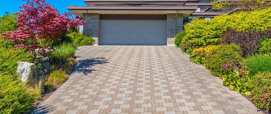 A patterned driveway surrounded by landscaping at a home in Grand Rapids, MI.