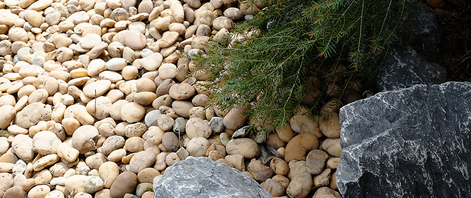 A landscape bed topped with rock on a property in Grand Rapids, MI.