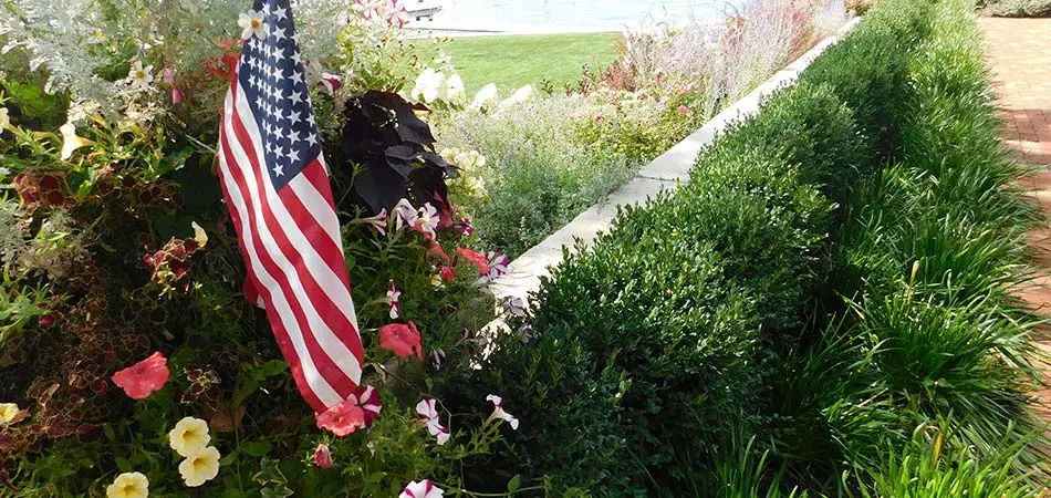 American flag on custom softscape and hardscape installation in Spring Lake, MI.
