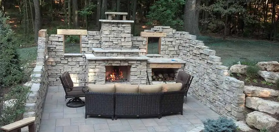 Custom stone outdoor fireplace designed and installed in Plainfield, MI.