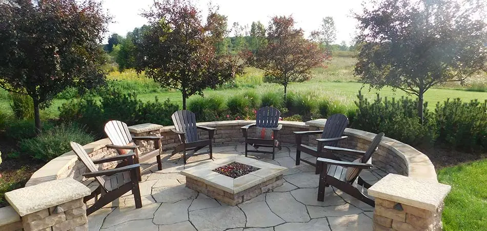 Custom stone fire pit and seating area in Grand Rapids, MI.