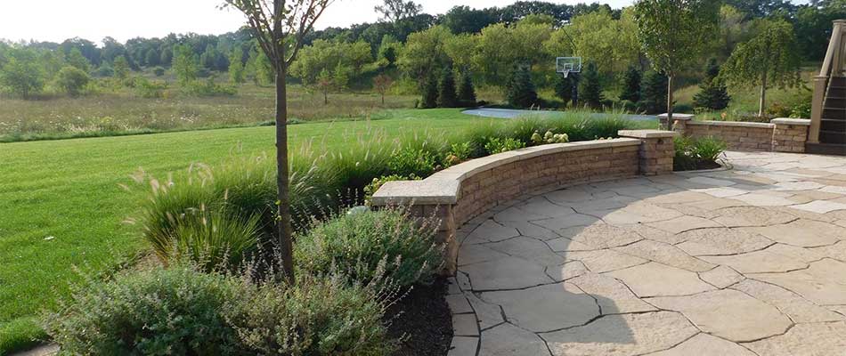 Custom retaining wall and landscaping installed in Rockford, Michigan.