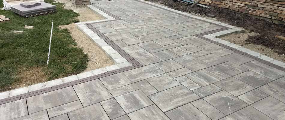 Custom stone walkway and patio being installed in Hudsonville, MI.