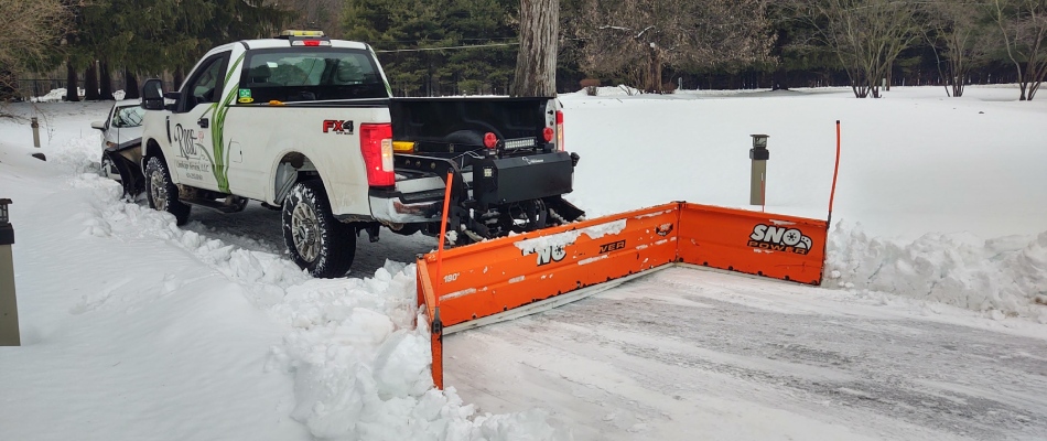 Back plow on truck for snow removal in driveway in Grandville, MI.