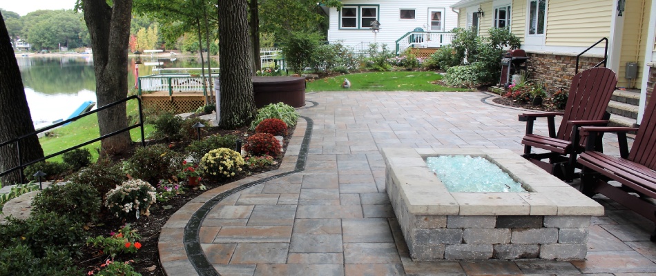 Custom stone paver fire pit and patio installed for clients in Marne, MI.