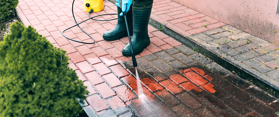 Dirty pavers being cleaned by a professional in Comstock Park, MI.