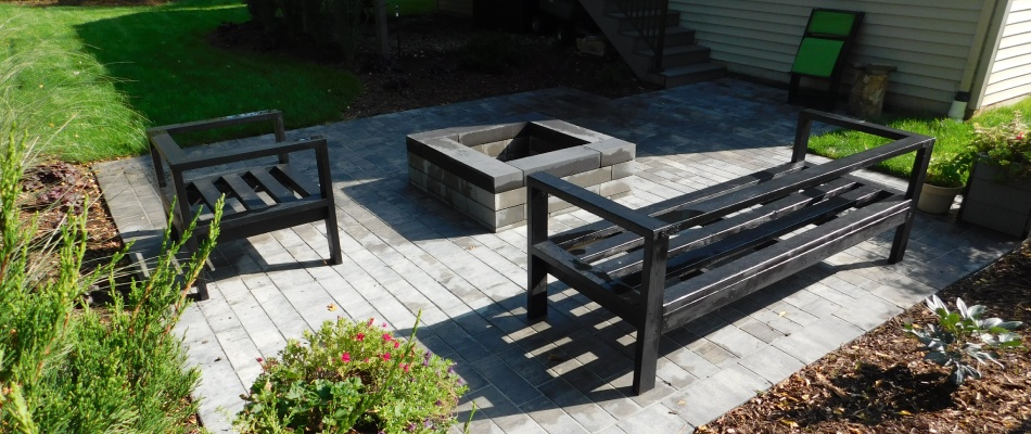 Fire pit installed on back patio with benches in Grand Rapids, MI.