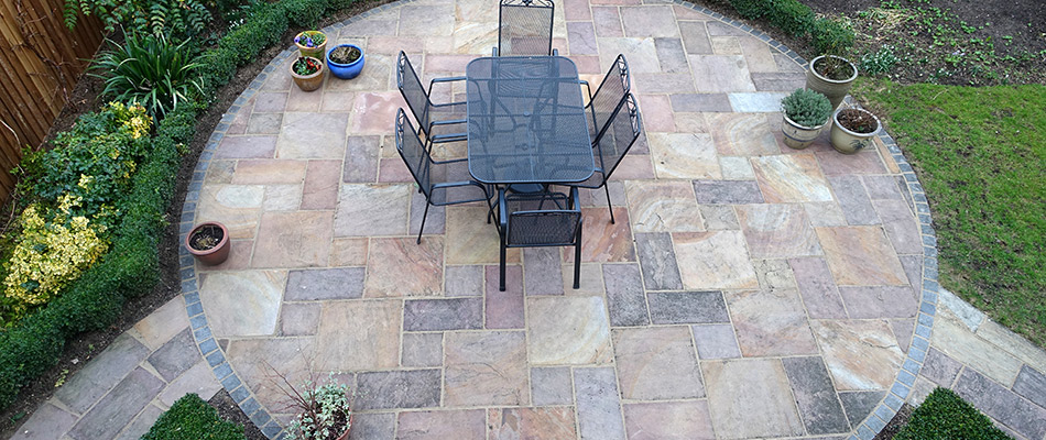 An elegant patio made with a herringbone pattern and high end materials.