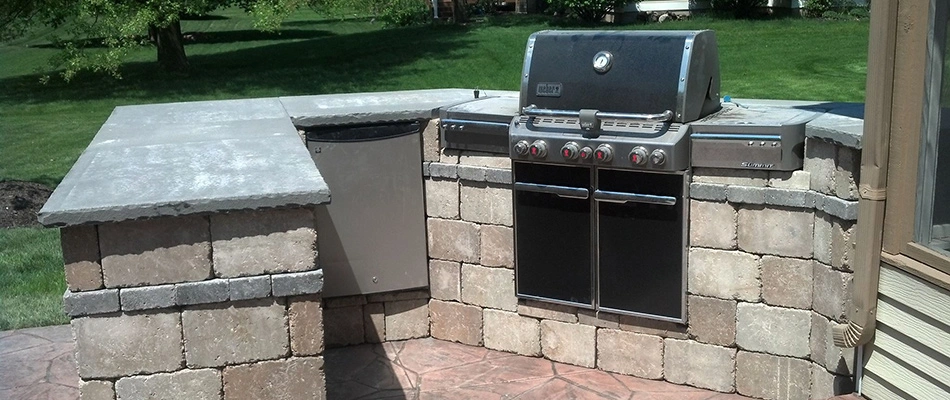 Custom built outdoor kitchen installed by Rose Landscaping professionals in Norton Shores, MI.