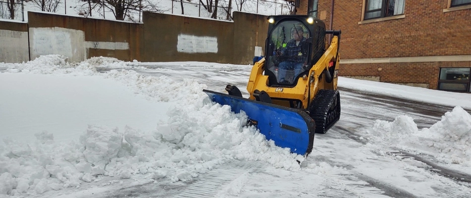 Rose professional removing snow from property in Ada, MI.