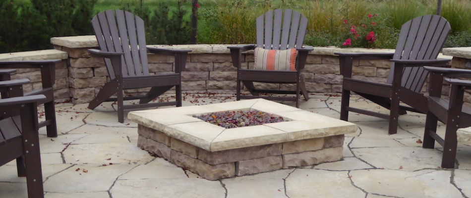 A custom built square fire pit installed on back patio in Ada, MI.